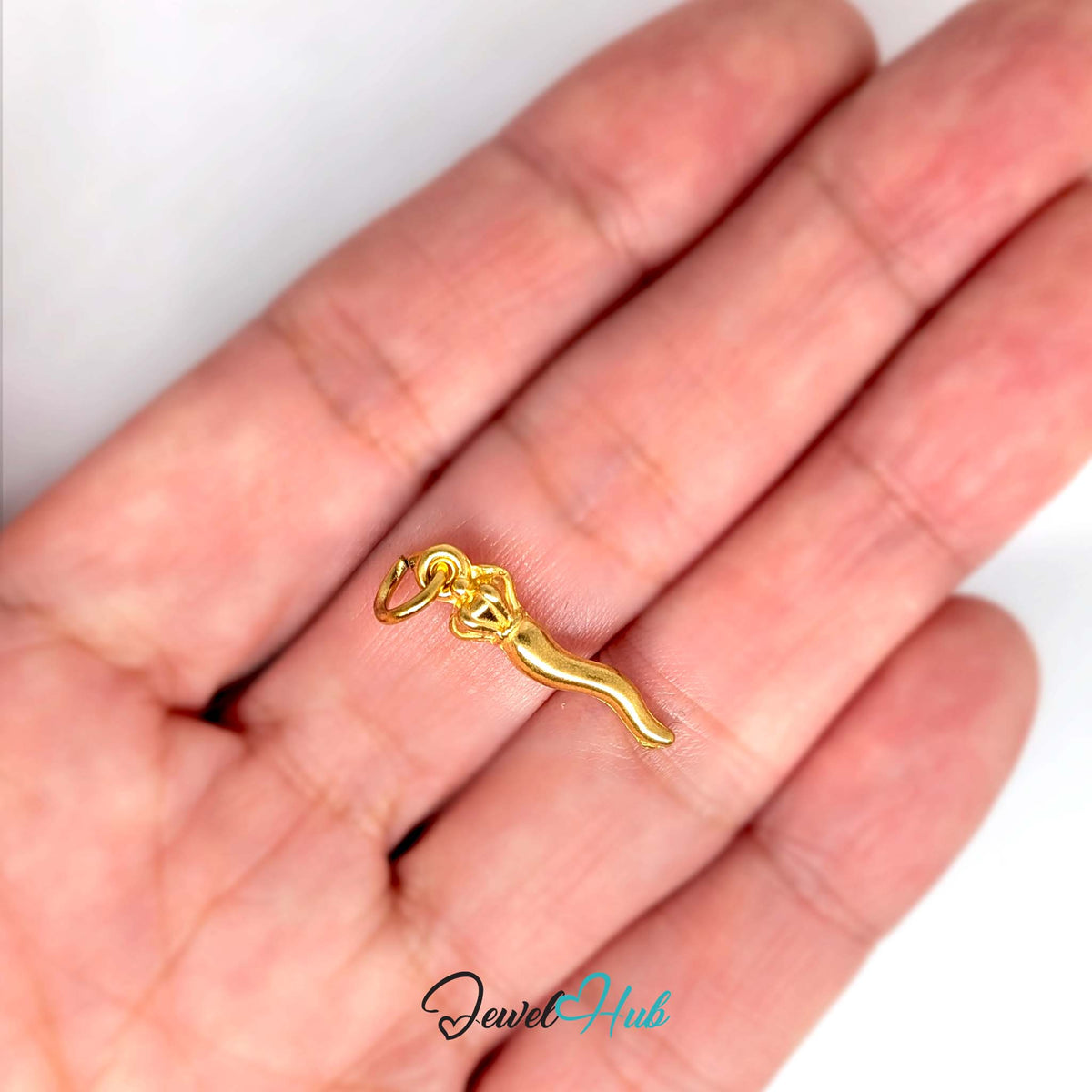 Twisted long pepper charm held in a hand to show its size - JewelHub