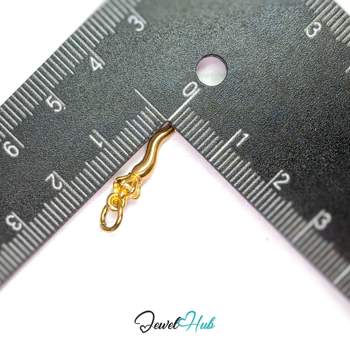 Twisted long pepper charm measured against a ruler at 4.5mm wide by 19.3mm tall - JewelHub