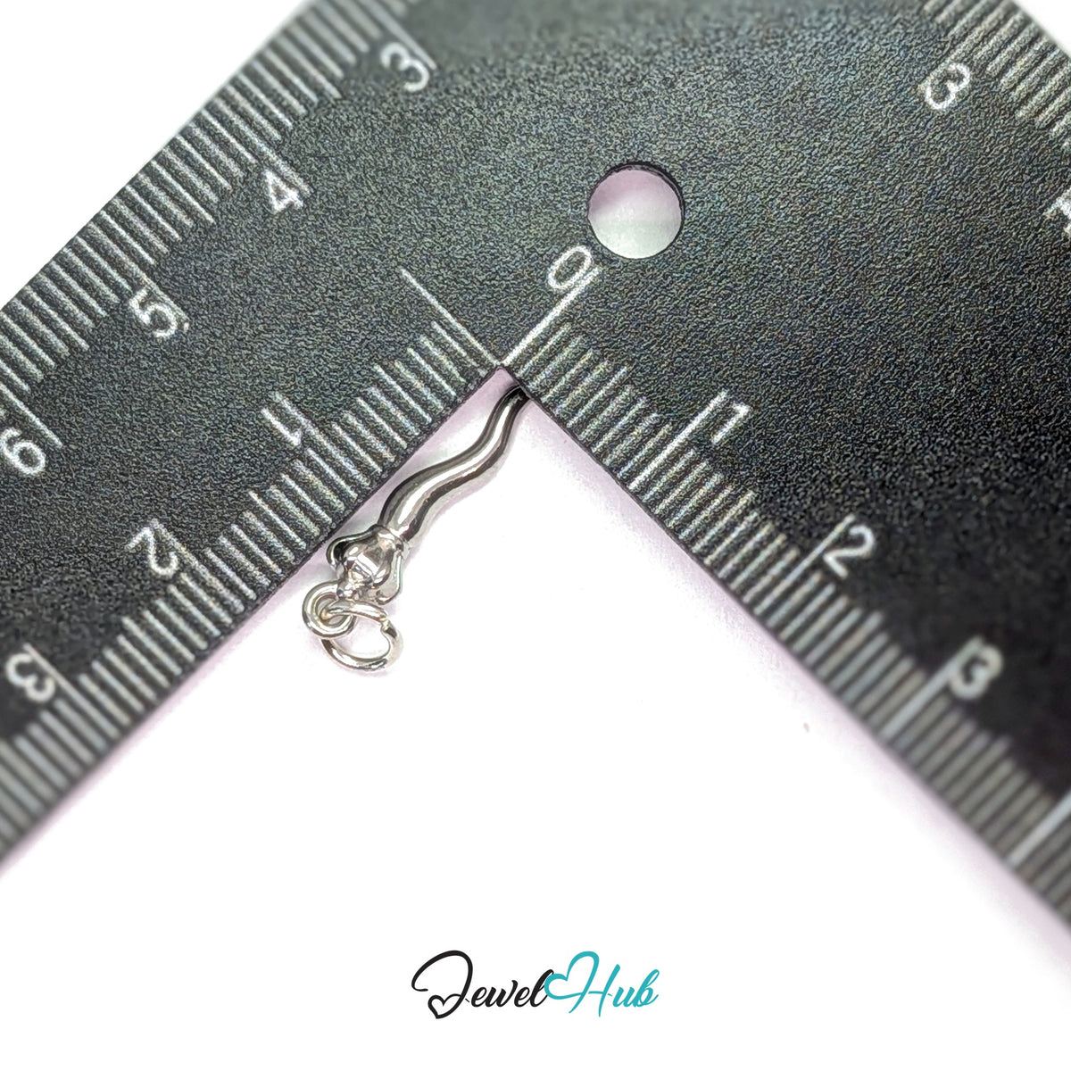 Twisted long pepper charm measured against a ruler at 4.5mm wide by 19.3mm tall - JewelHub