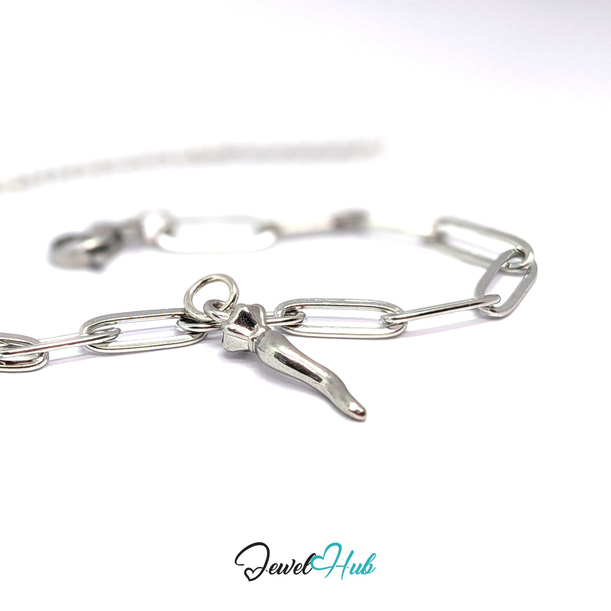 Silver-tone twisted long pepper charm styled on a silver paperclip chain bracelet - JewelHub