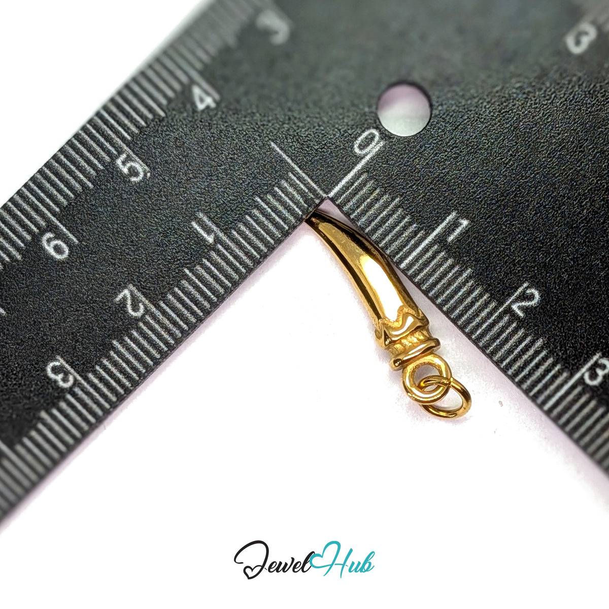 Large long pepper charm measured against a ruler at 5.6mm wide by 24.1mm tall - JewelHub