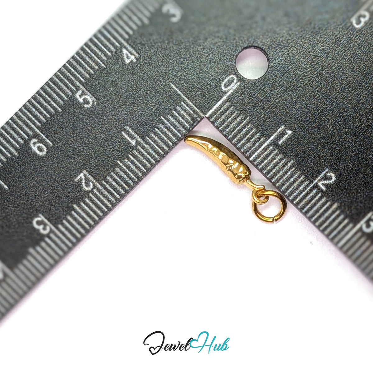 Mini chilli pepper charm measured against a ruler at 4mm wide by 17mm tall - JewelHub