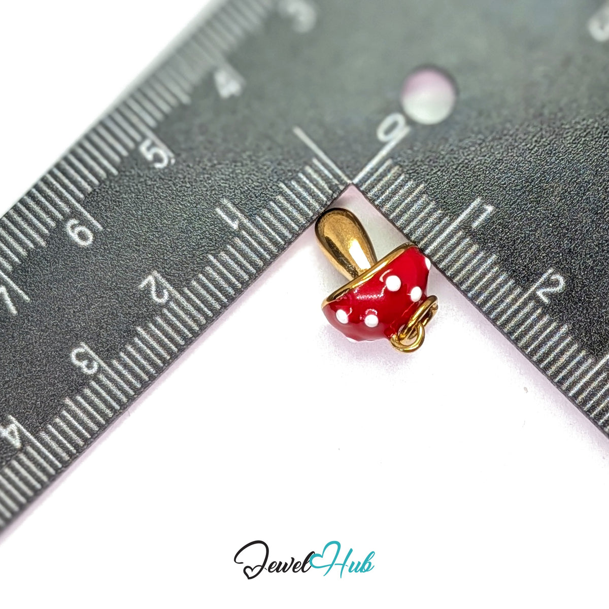Red spotted mushroom charm measured against a ruler at 11.6mm wide by 17.3mm tall - JewelHub