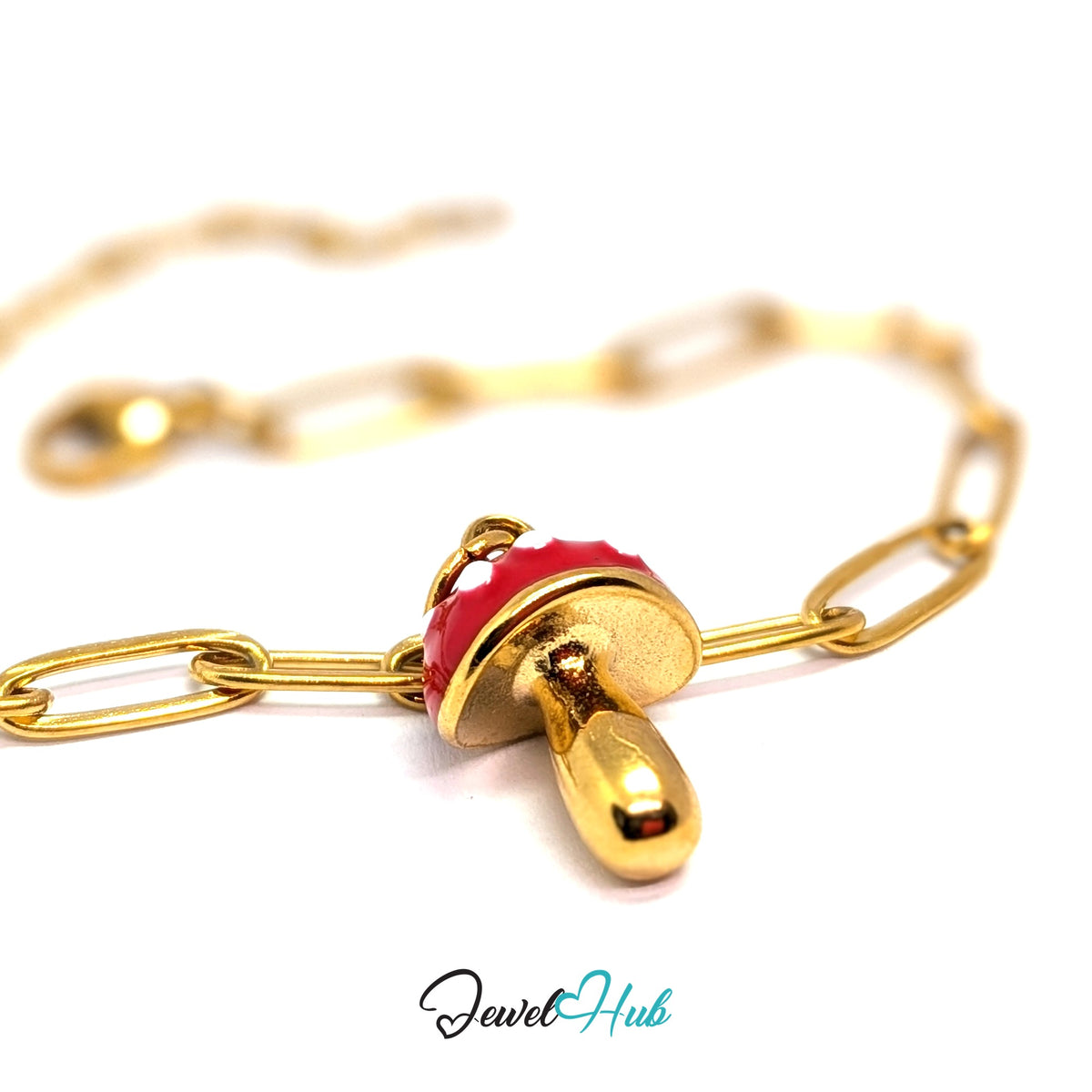 Gold-tone red spotted mushroom charm styled on a gold paperclip chain bracelet - JewelHub