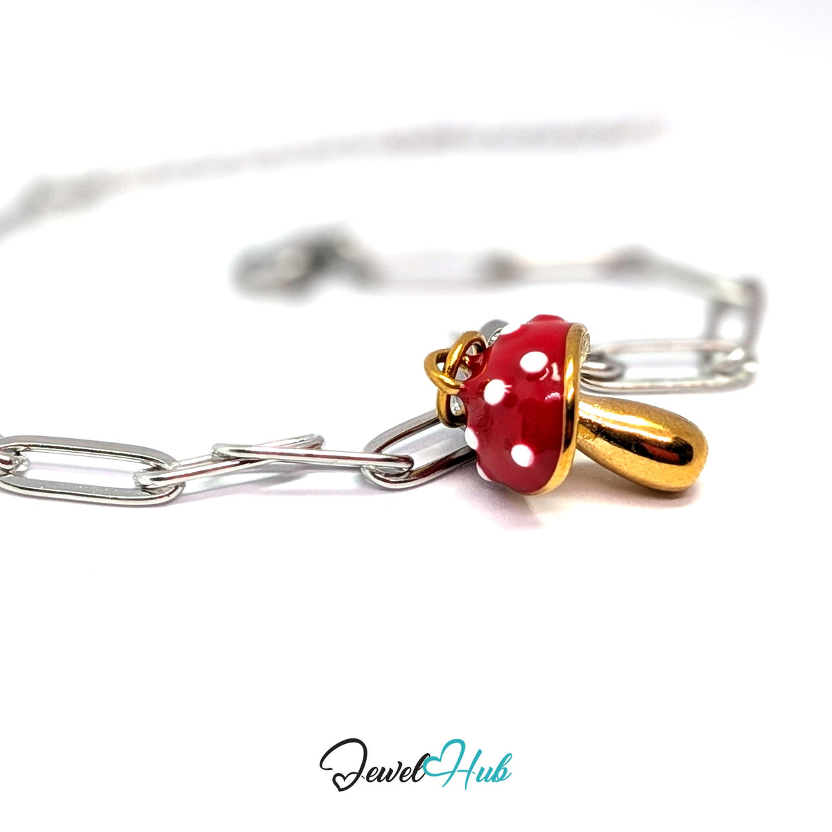 Gold-tone red spotted mushroom charm styled on a silver paperclip chain bracelet for a two-tone look - JewelHub