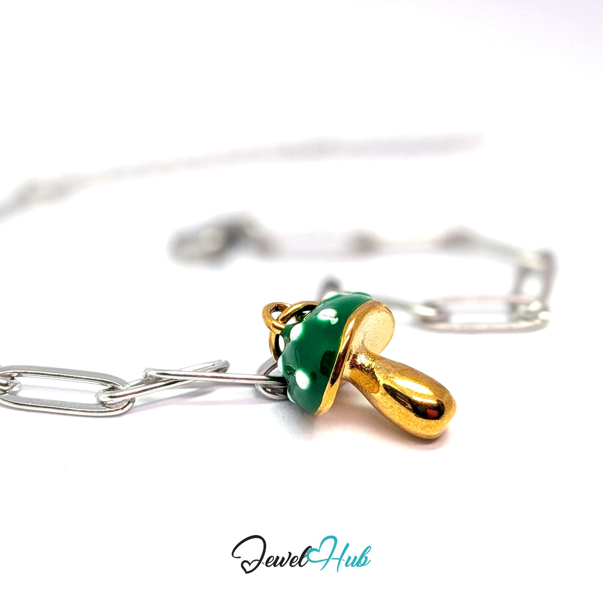Gold-tone green spotted mushroom charm styled on a silver paperclip chain bracelet for a two-tone look - JewelHub