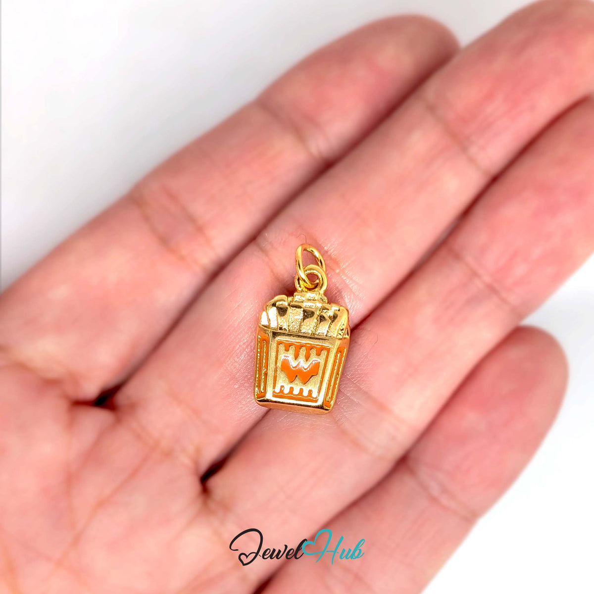 Orange enamel French fries charm held in a hand to show its size - JewelHub