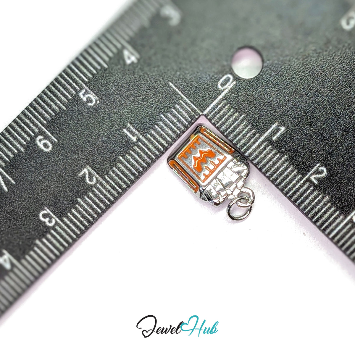 Orange enamel French fries charm measured against a ruler at 10.6mm wide by 16.7mm tall - JewelHub