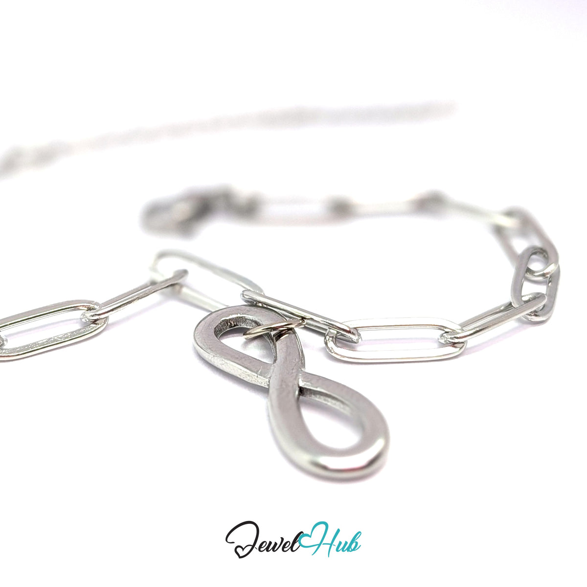 Silver-tone infinity charm styled on a silver paperclip chain bracelet - JewelHub