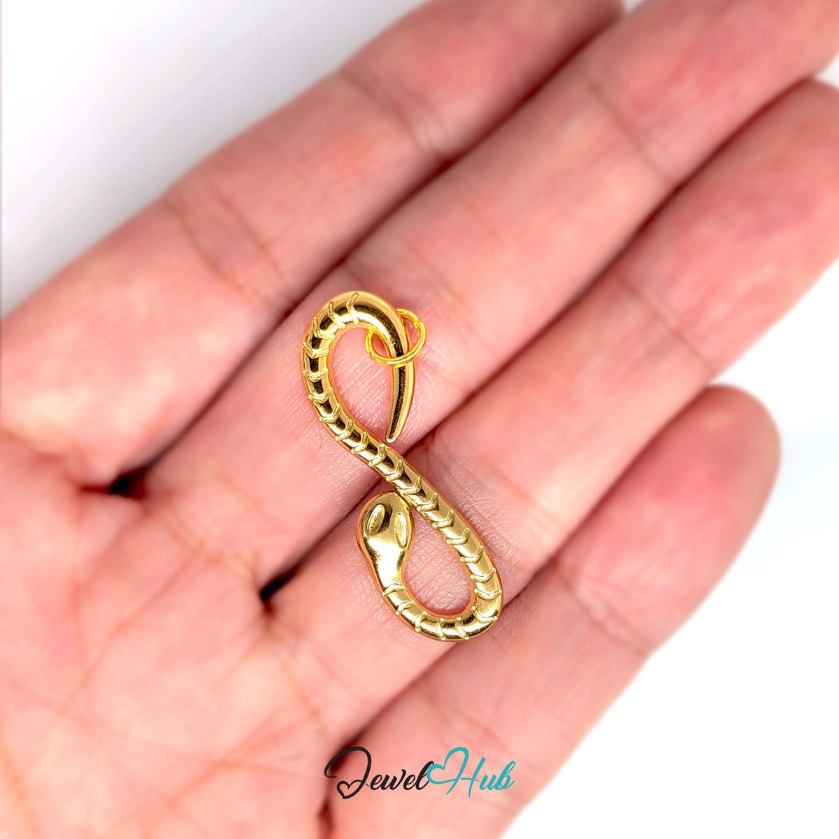 Infinity snake charm held in a hand to show its size - JewelHub