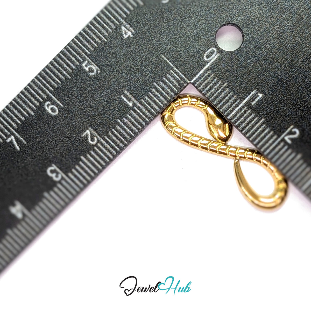 Infinity snake charm measured against a ruler at 10mm wide by 30.3mm tall - JewelHub