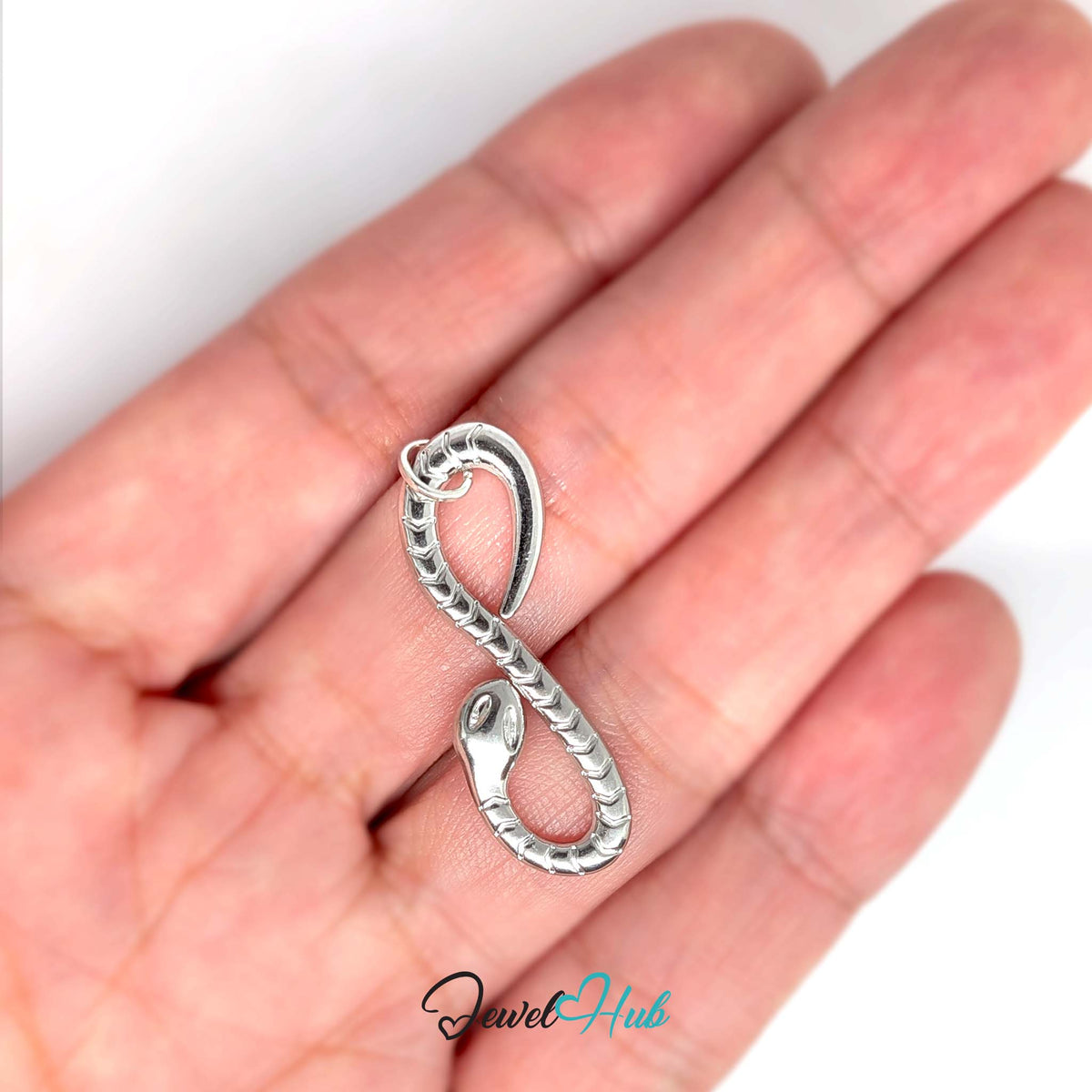 Infinity snake charm held in a hand to show its size - JewelHub