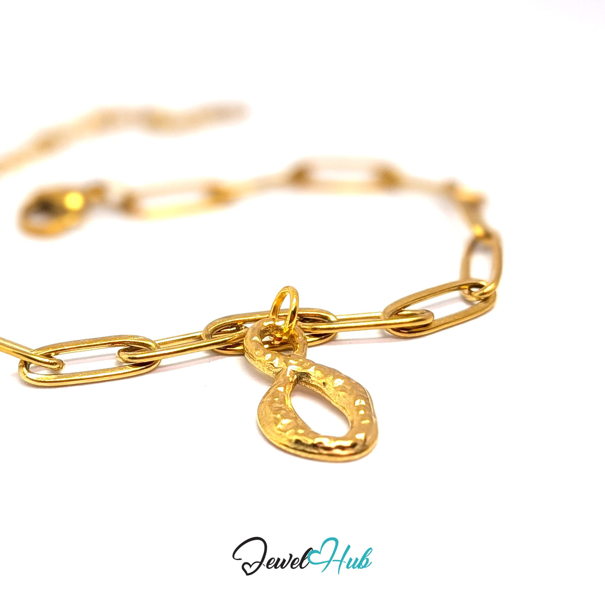 Gold-tone textured infinity charm styled on a gold paperclip chain bracelet - JewelHub