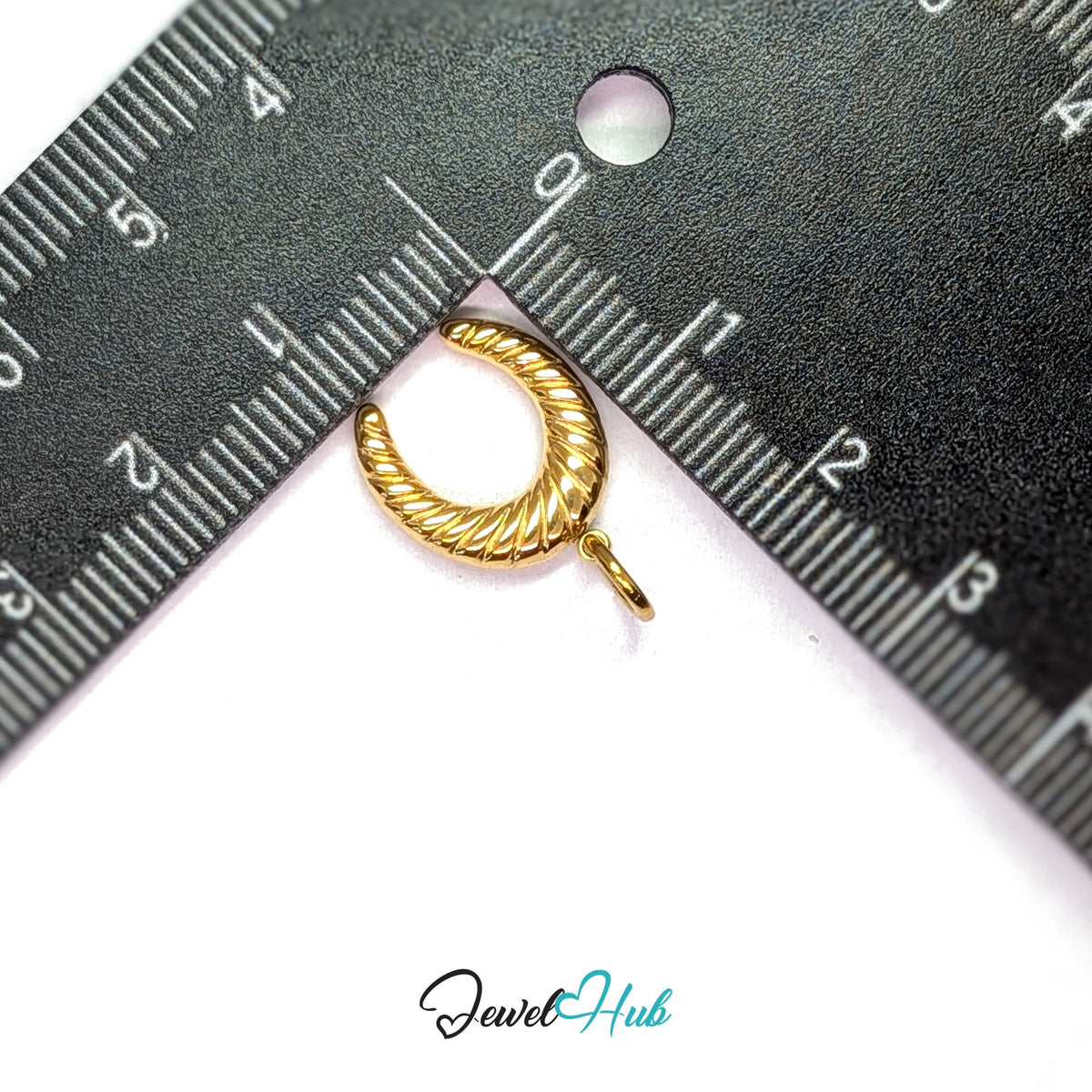 Ribbed horseshoe charm measured against a ruler at 13.3mm wide by 15.7mm tall - JewelHub