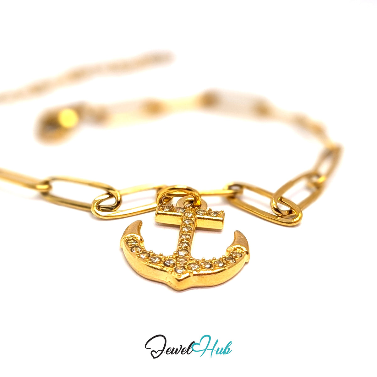 Gold-tone crystal anchor charm styled on a gold paperclip chain bracelet - JewelHub
