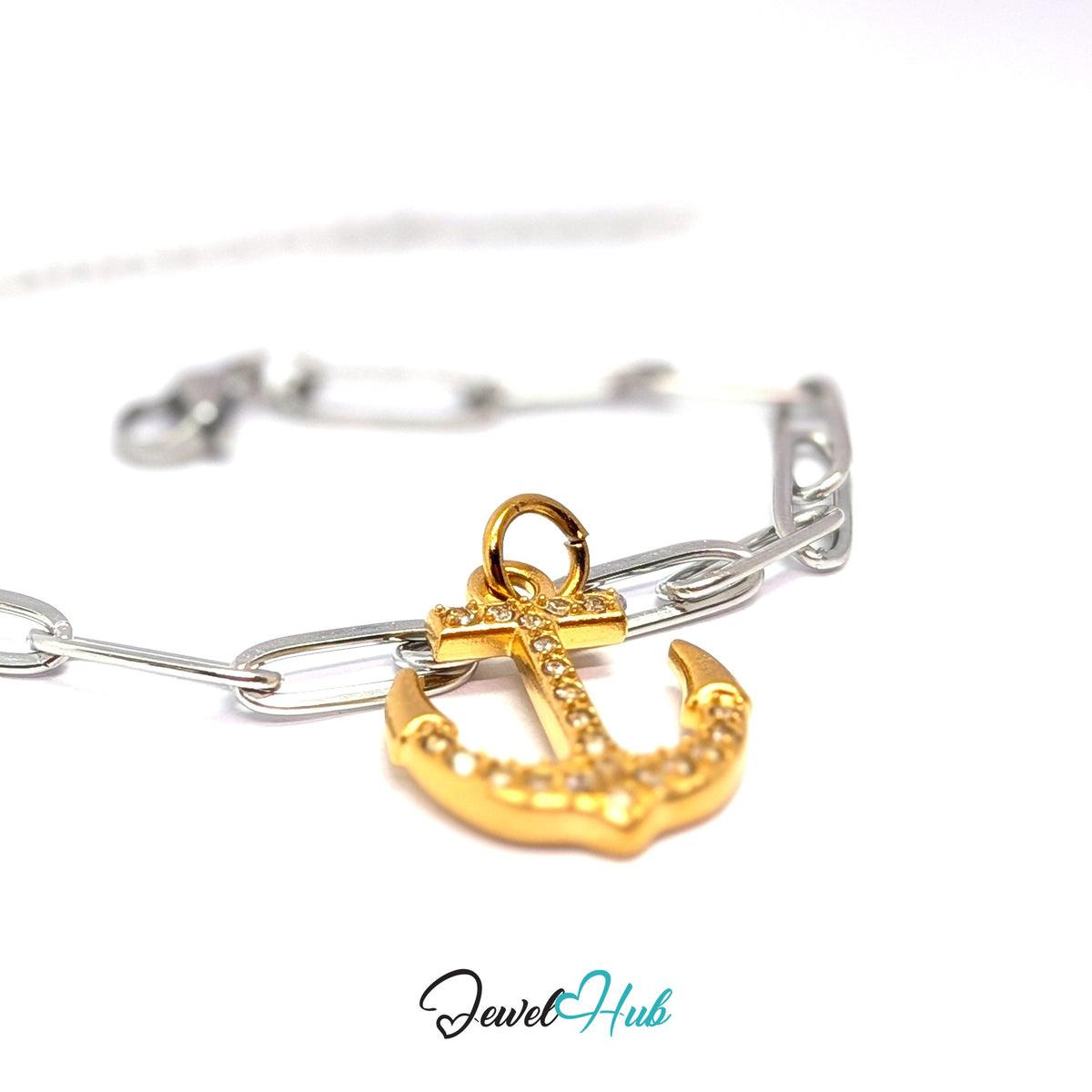 Gold-tone crystal anchor charm styled on a silver paperclip chain bracelet for a two-tone look - JewelHub