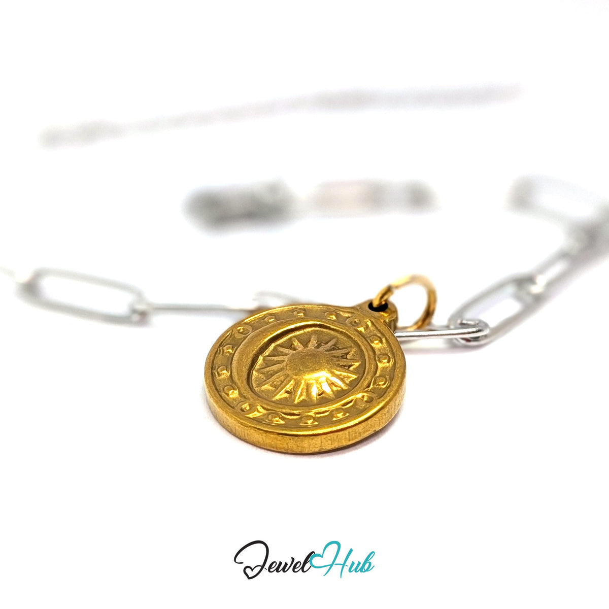 Gold-tone sun medallion charm styled on a silver paperclip chain bracelet for a two-tone look - JewelHub