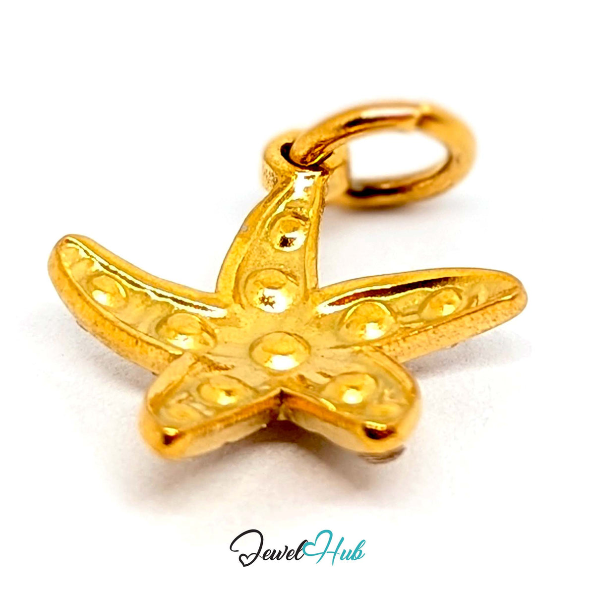 Close-up of the gold-tone crystal starfish charm detail - JewelHub