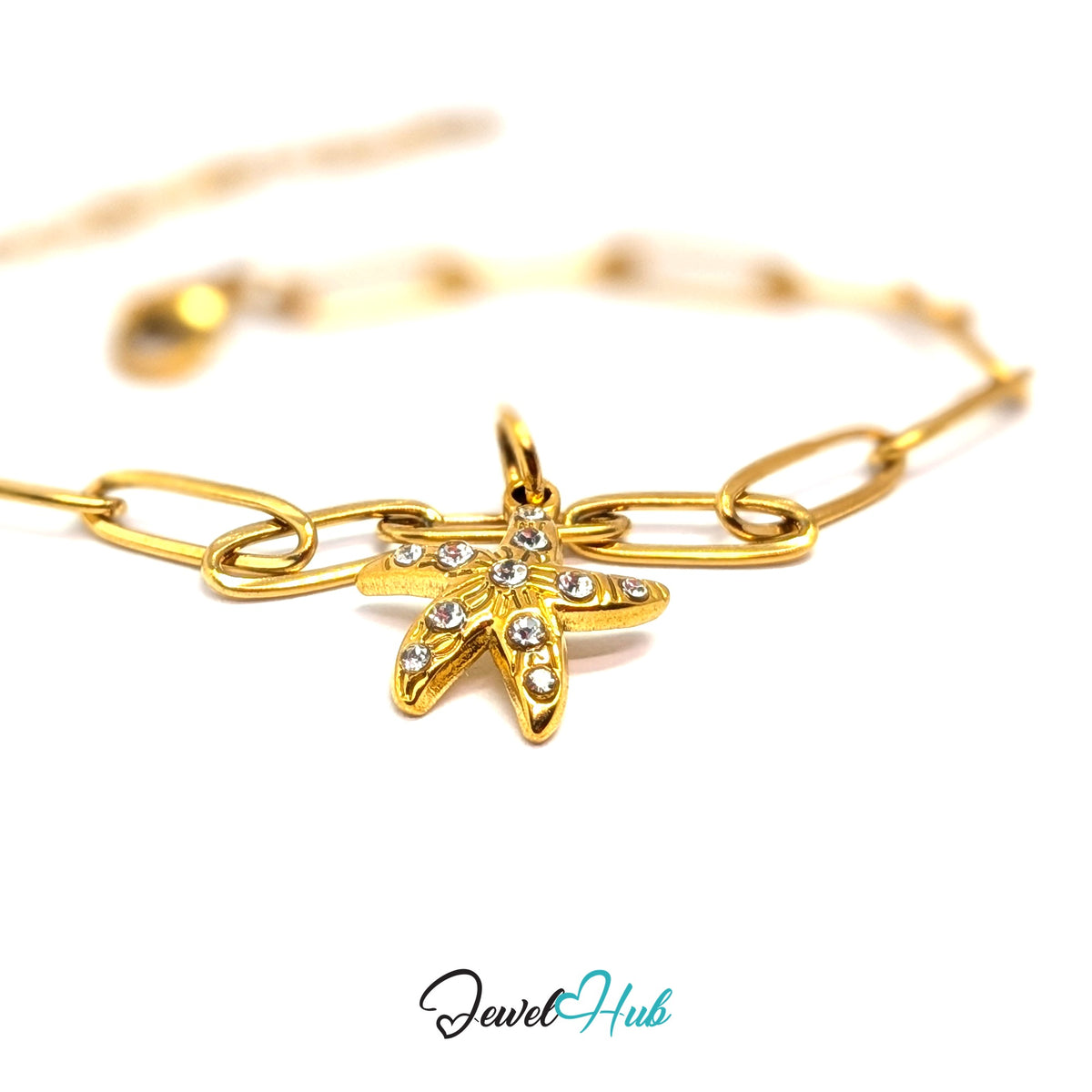 Gold-tone crystal starfish charm styled on a gold paperclip chain bracelet - JewelHub