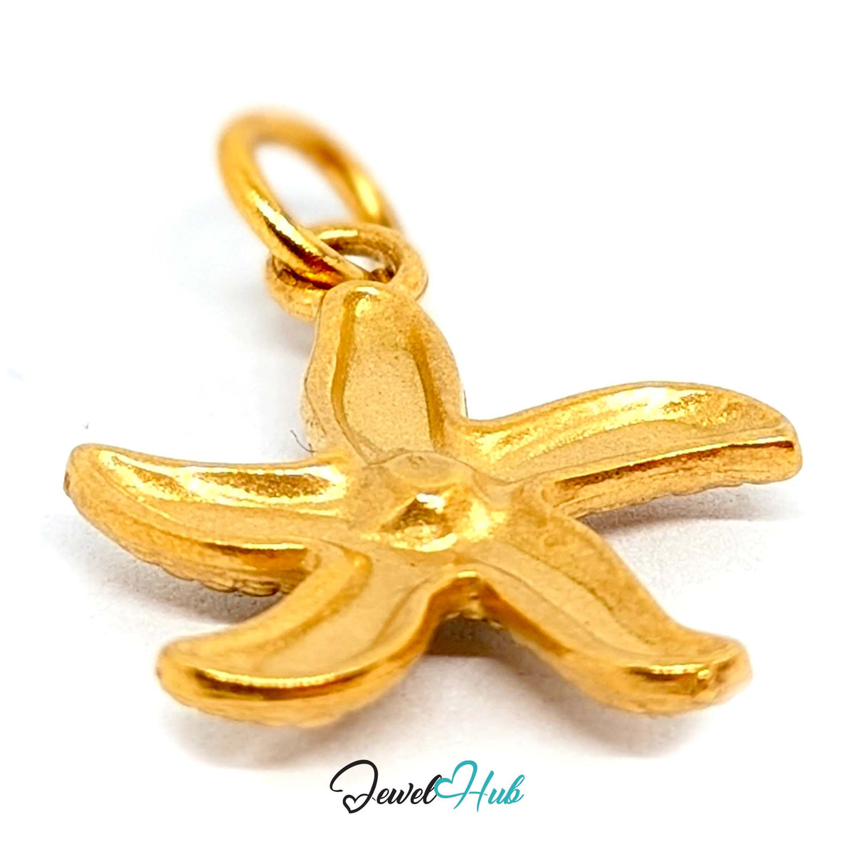 Close-up of the gold-tone textured starfish charm detail - JewelHub