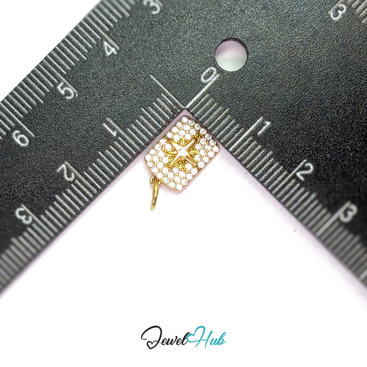 Crystal star tag charm measured against a ruler at 8.6mm wide by 13.2mm tall - JewelHub