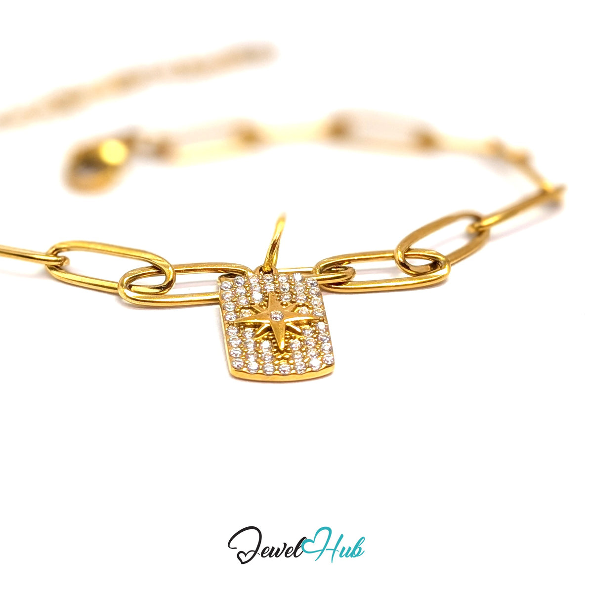 Gold-tone crystal star tag charm styled on a gold paperclip chain bracelet - JewelHub