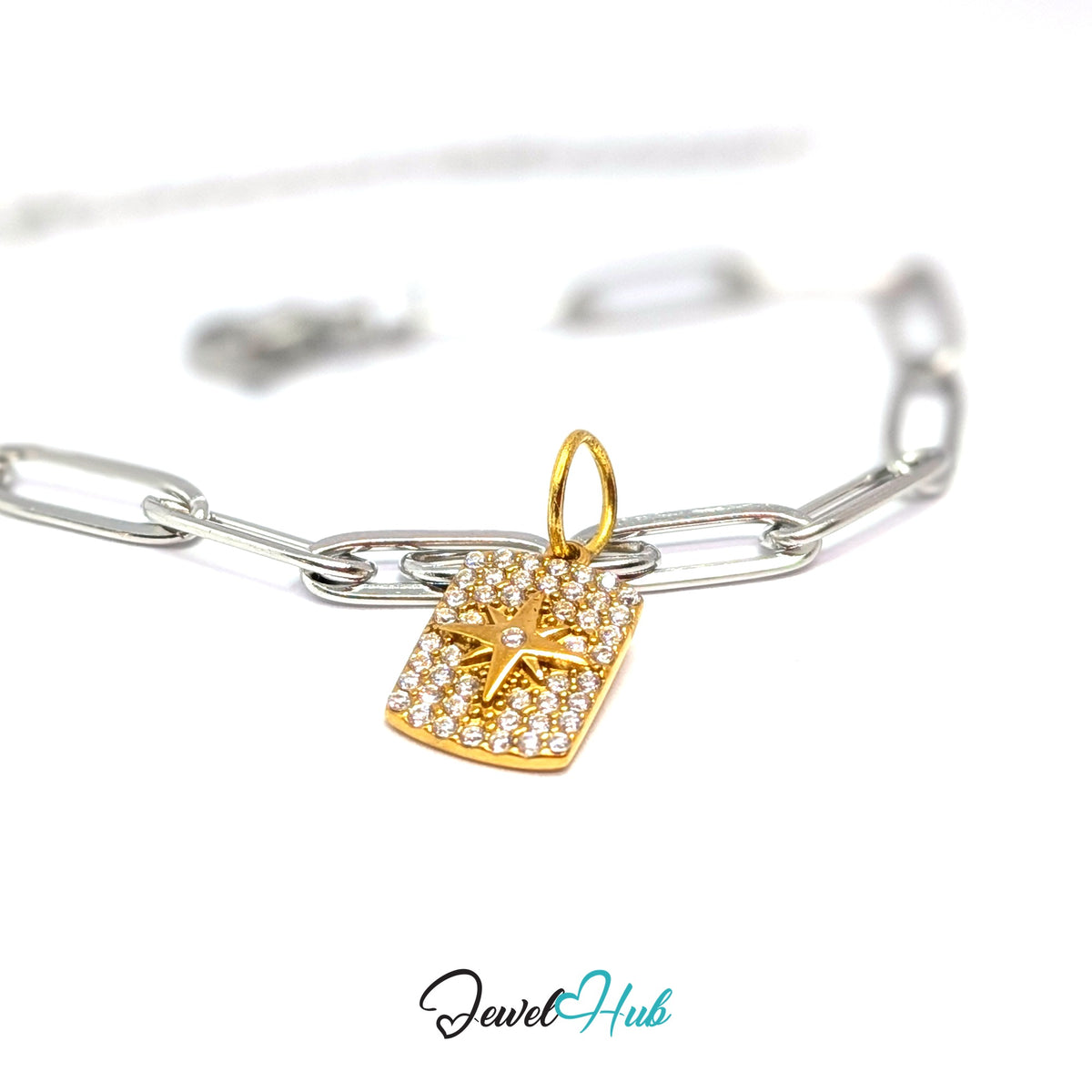 Gold-tone crystal star tag charm styled on a silver paperclip chain bracelet for a two-tone look - JewelHub