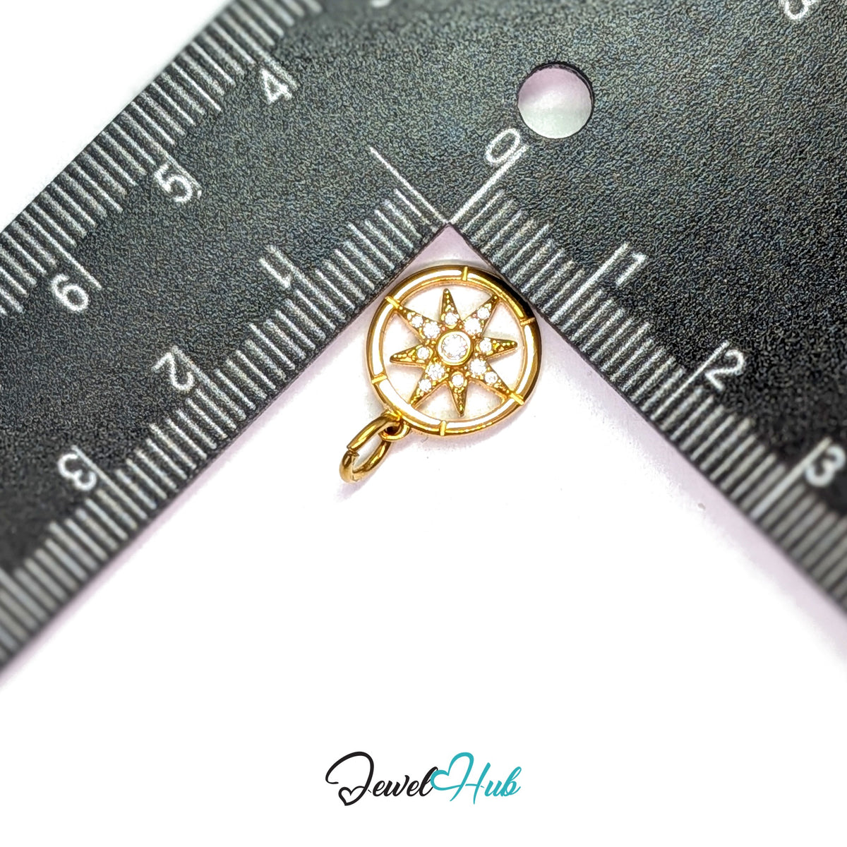 Crystal star compass charm measured against a ruler at 12.8mm wide by 14.7mm tall - JewelHub