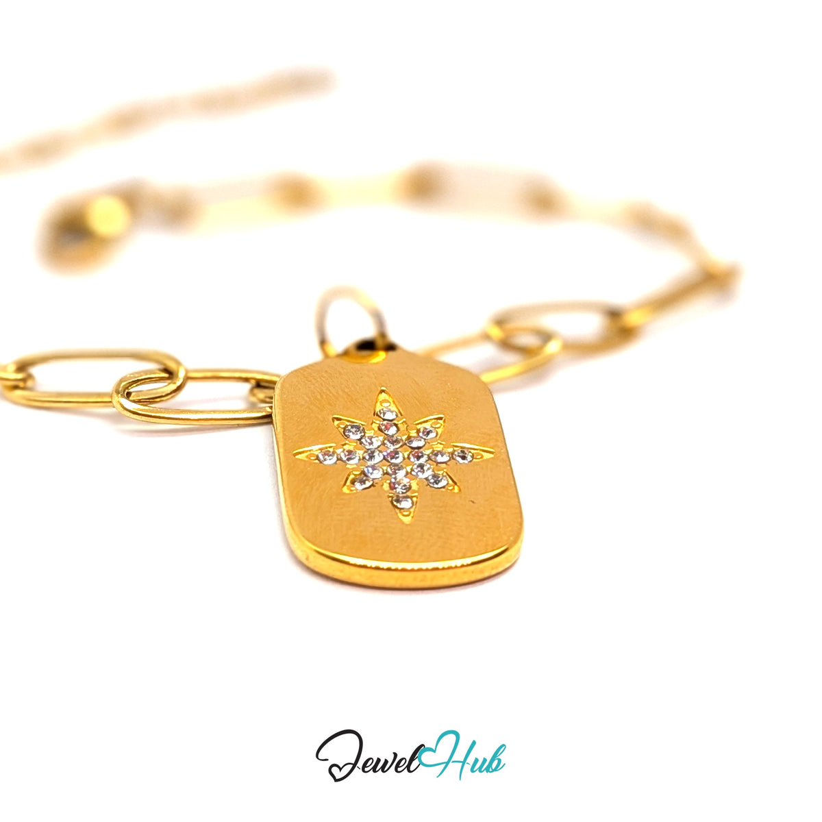 Gold-tone crystal star plate charm styled on a gold paperclip chain bracelet - JewelHub