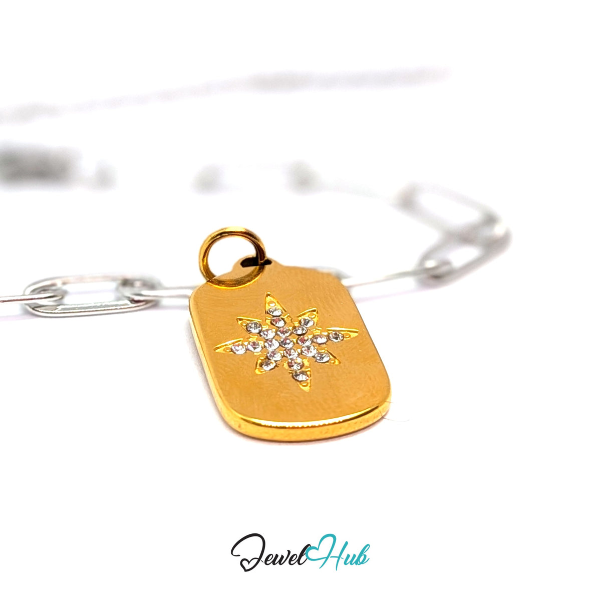 Gold-tone crystal star plate charm styled on a silver paperclip chain bracelet for a two-tone look - JewelHub
