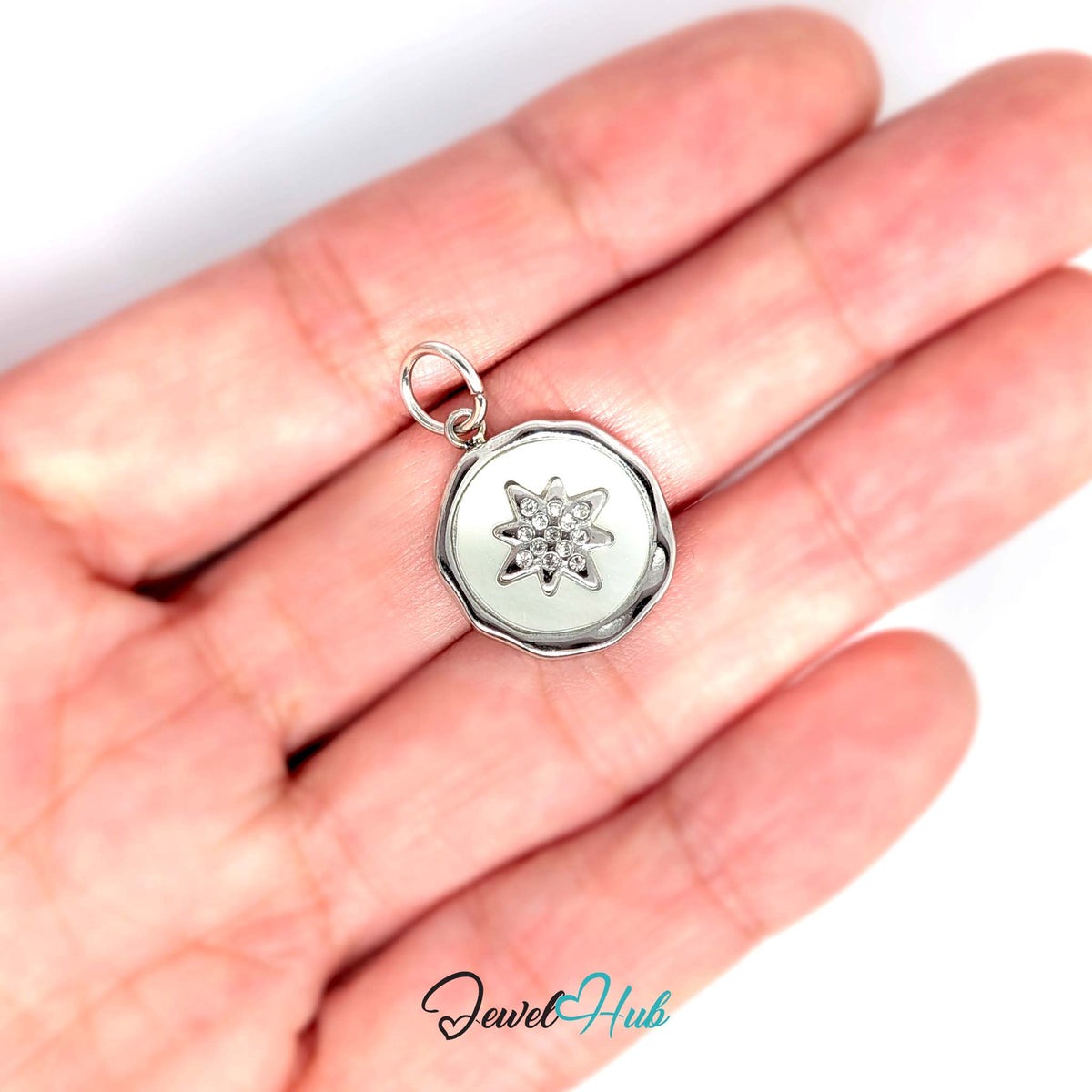 White star round charm held in a hand to show its size - JewelHub