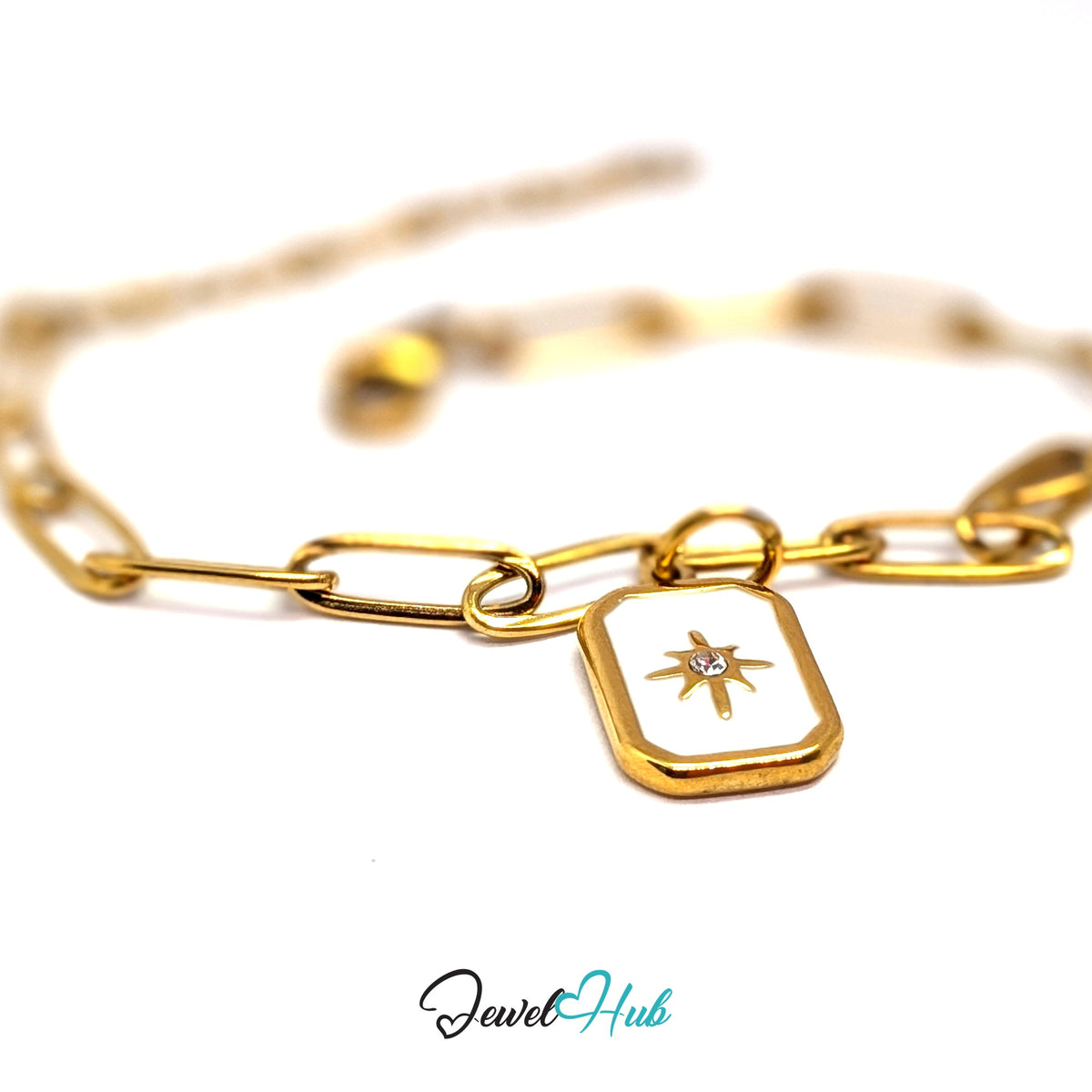 Gold-tone white star tag charm styled on a gold paperclip chain bracelet - JewelHub