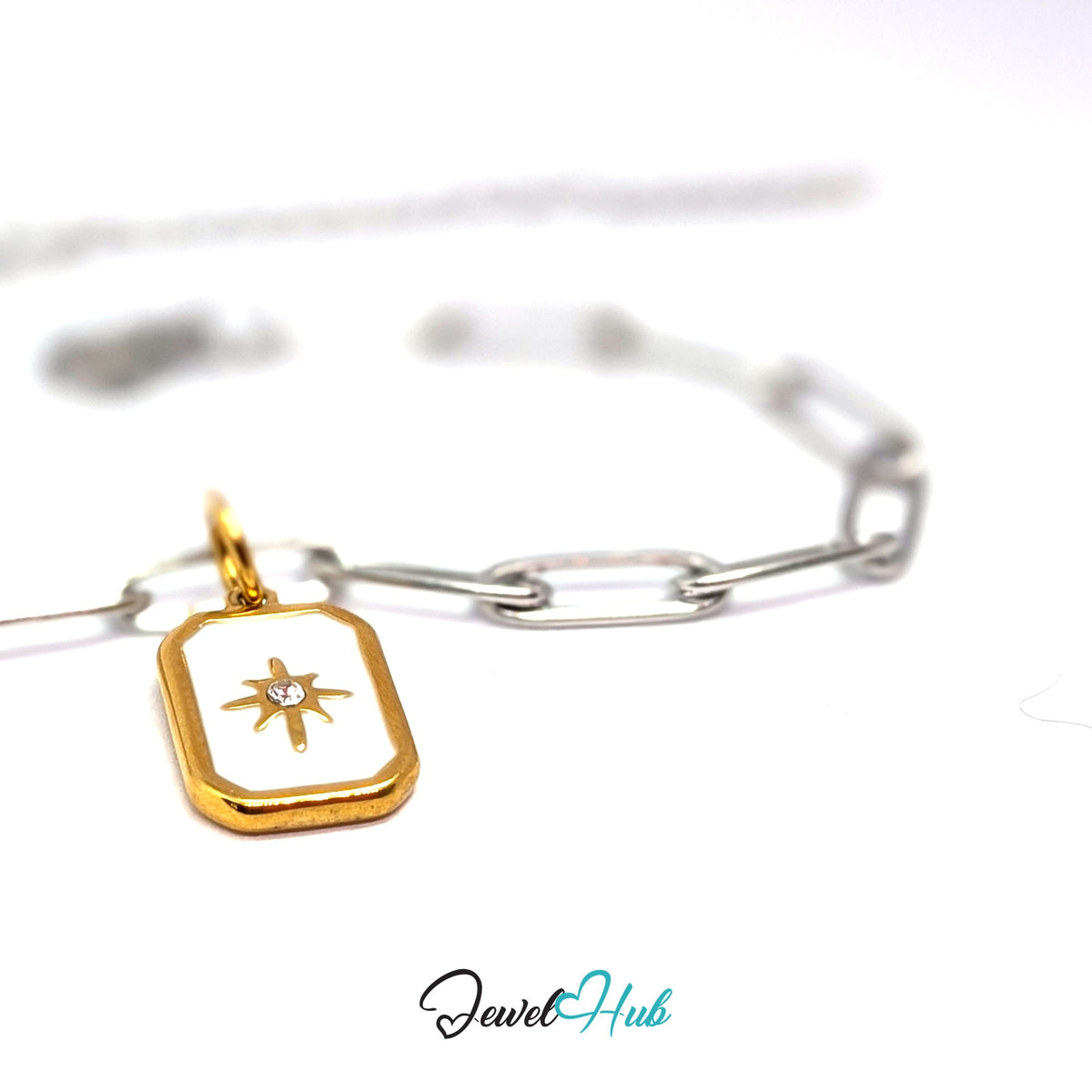 Gold-tone white star tag charm styled on a silver paperclip chain bracelet for a two-tone look - JewelHub