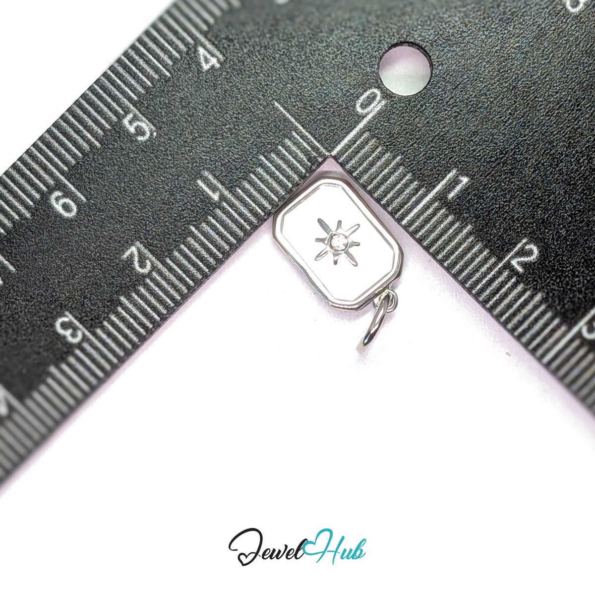 White star tag charm measured against a ruler at 10mm wide by 15.6mm tall - JewelHub