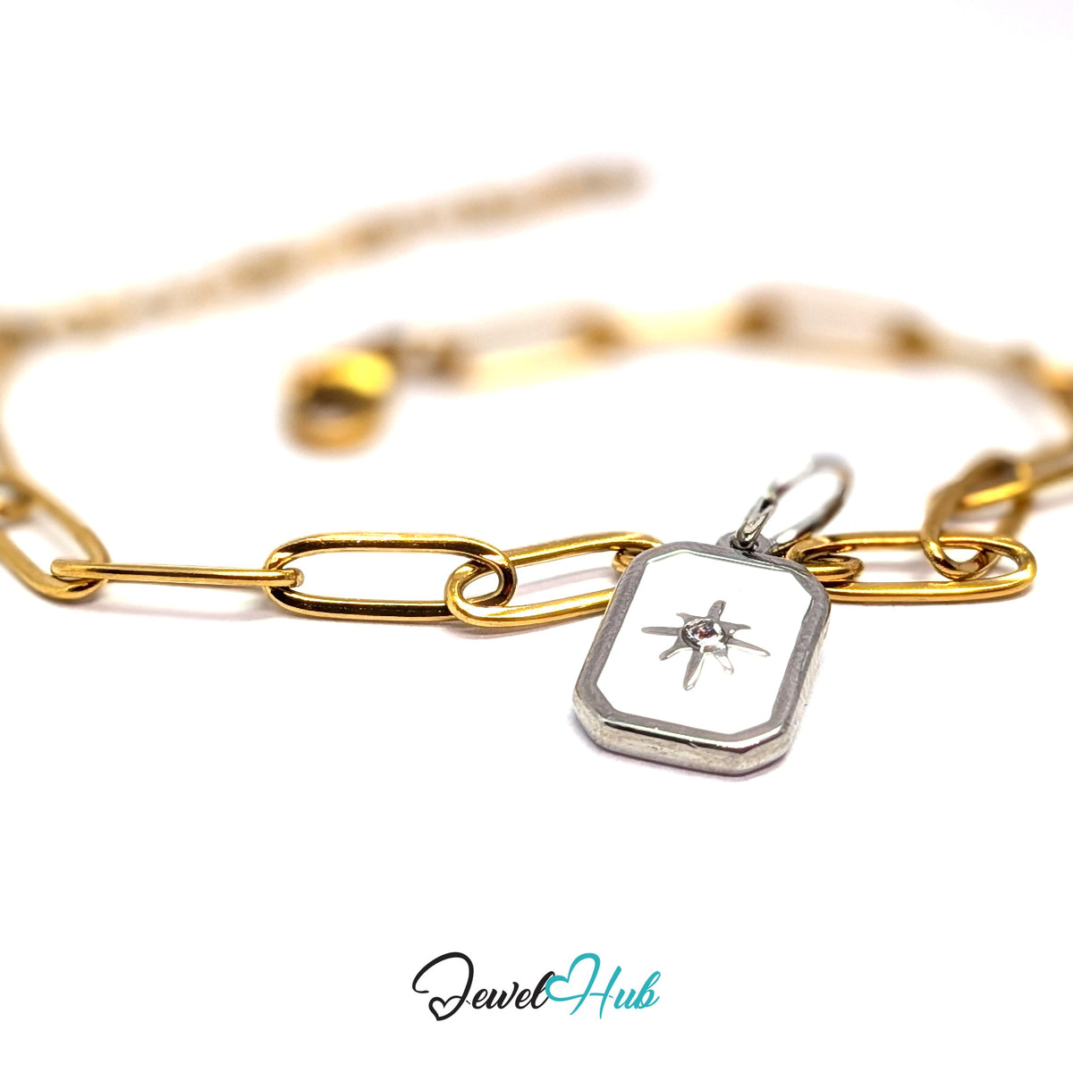 Silver-tone white star tag charm styled on a gold paperclip chain bracelet for a two-tone look - JewelHub