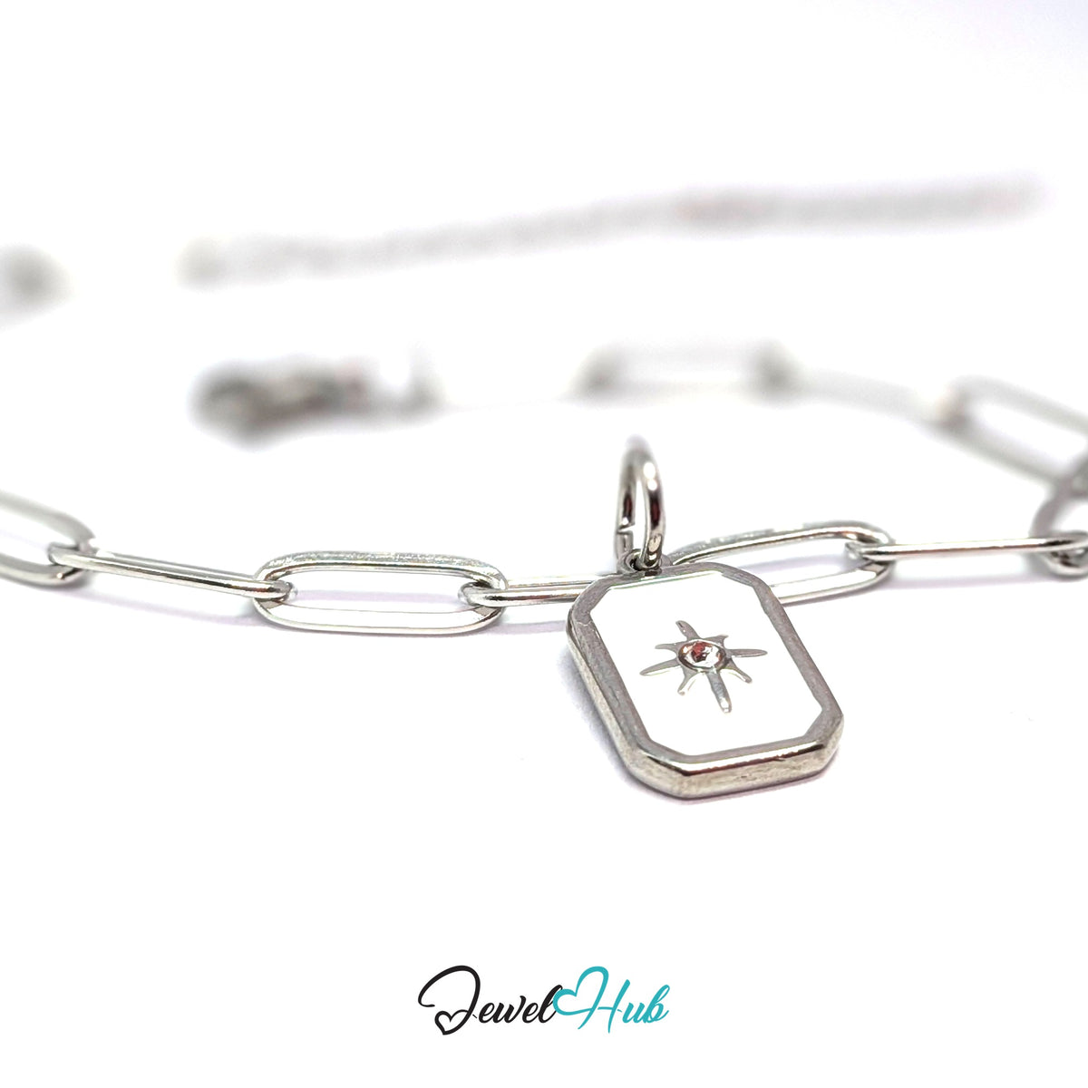 Silver-tone white star tag charm styled on a silver paperclip chain bracelet - JewelHub