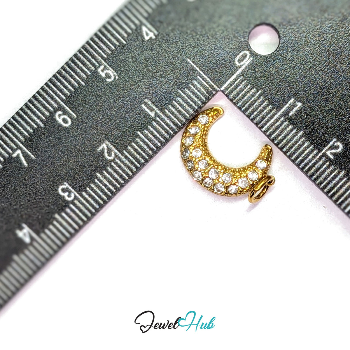 Crystal moon charm measured against a ruler at 13mm wide by 18.4mm tall - JewelHub