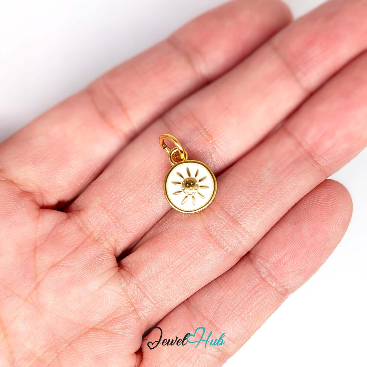 White sun charm held in a hand to show its size - JewelHub