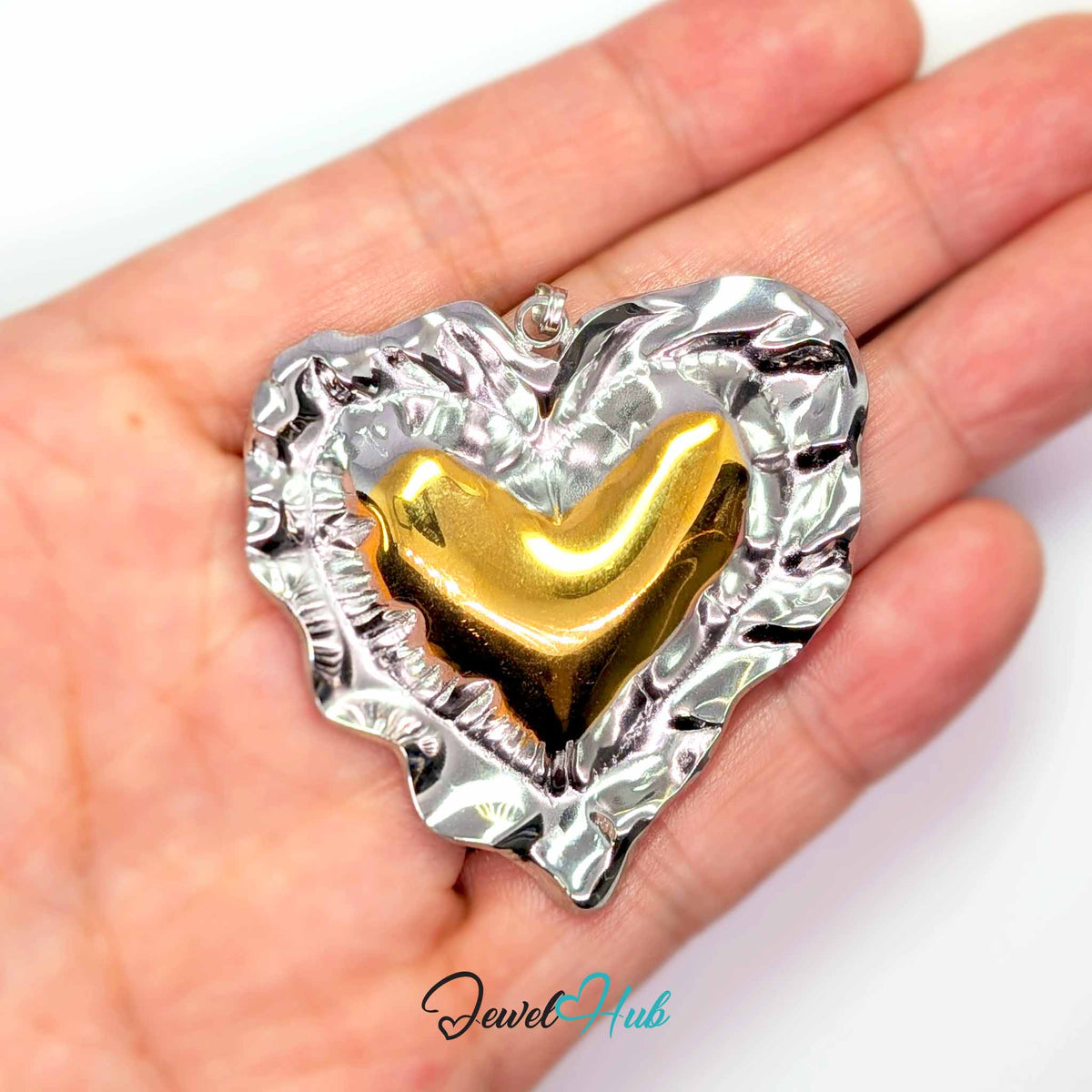 Giant Wrinkle Heart pendant in DuoTone stainless steel - held in the hand to show size - JewelHub