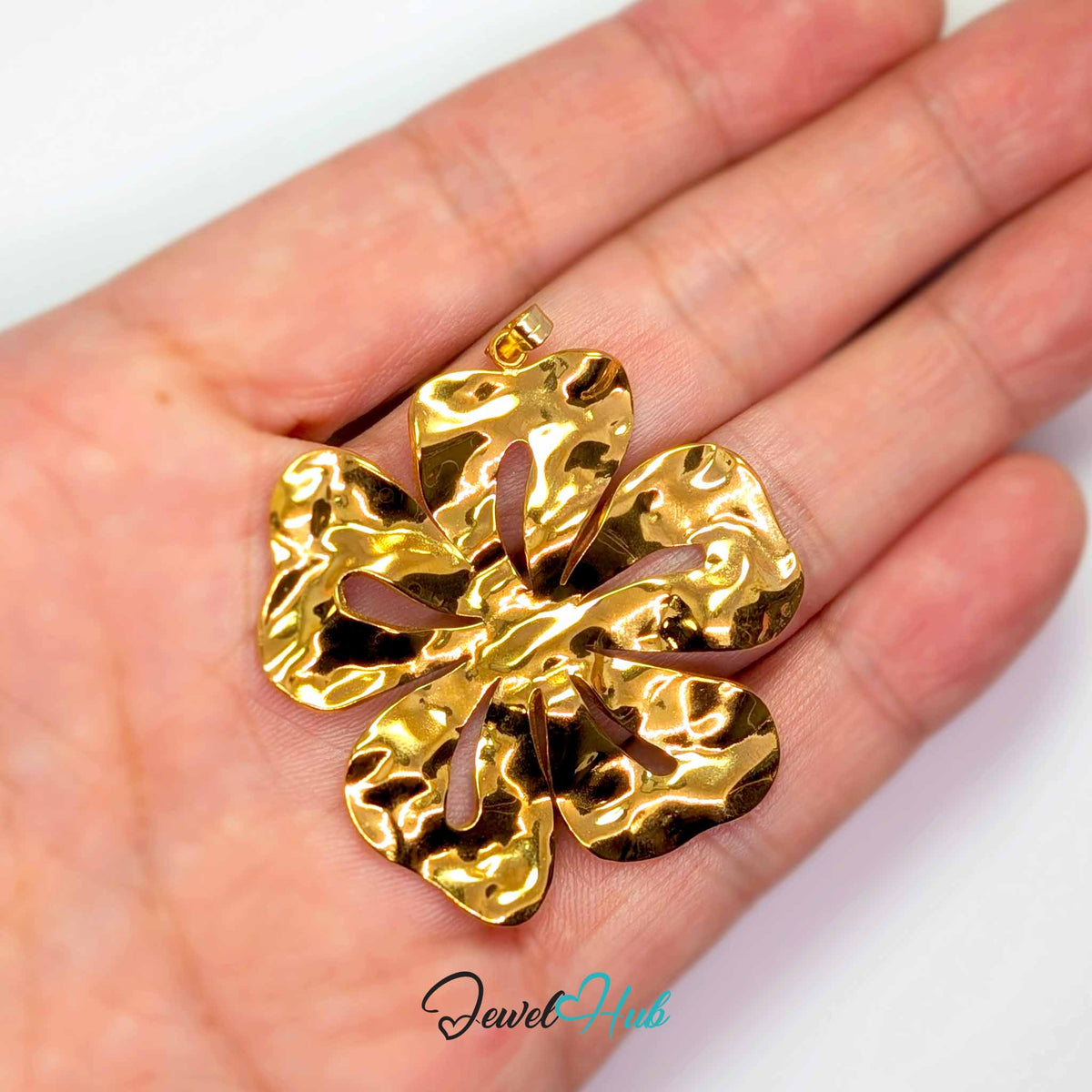 Giant Flower pendant in gold-tone stainless steel - held in the hand to show size - JewelHub