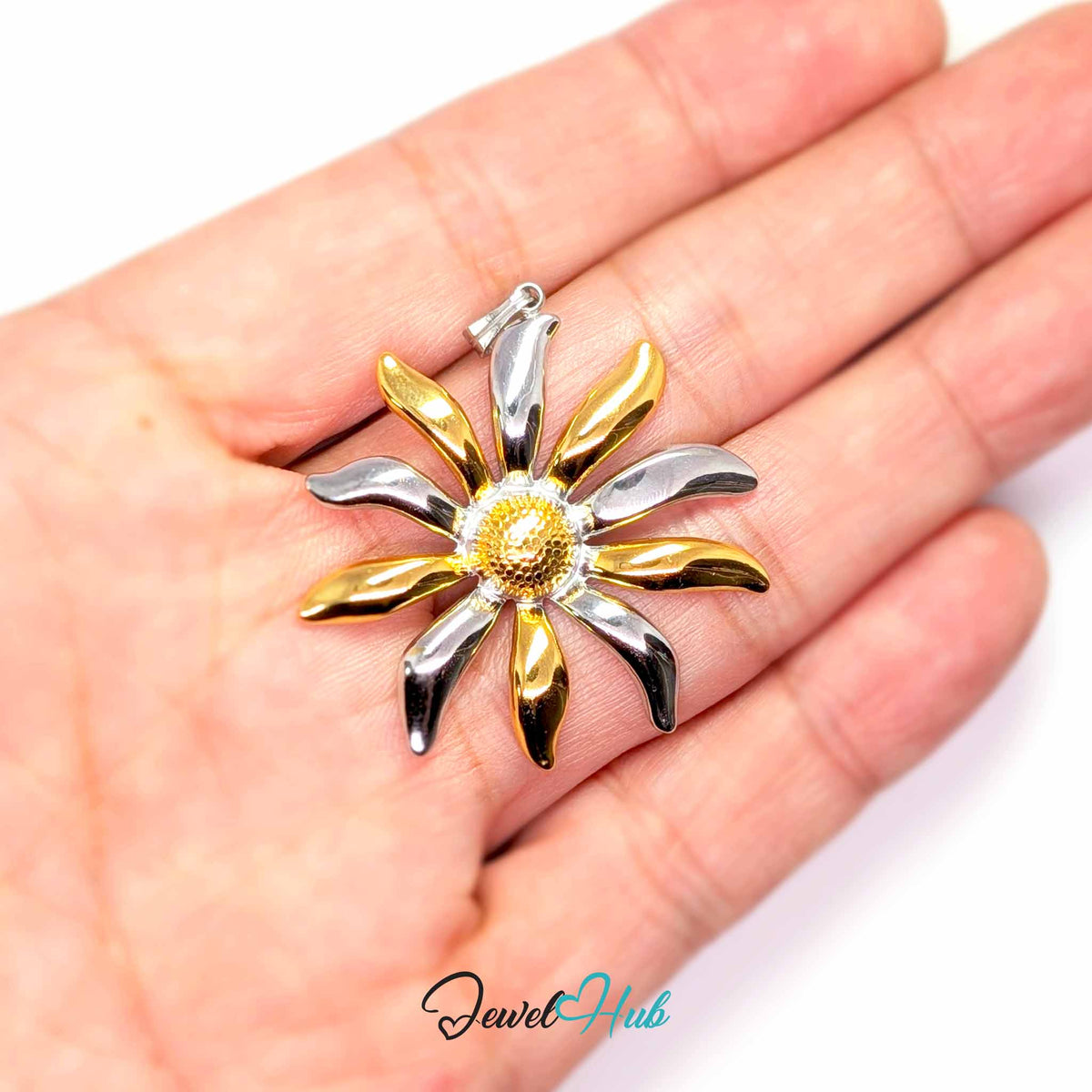Sunflower pendant in DuoTone stainless steel - held in the hand to show size - JewelHub