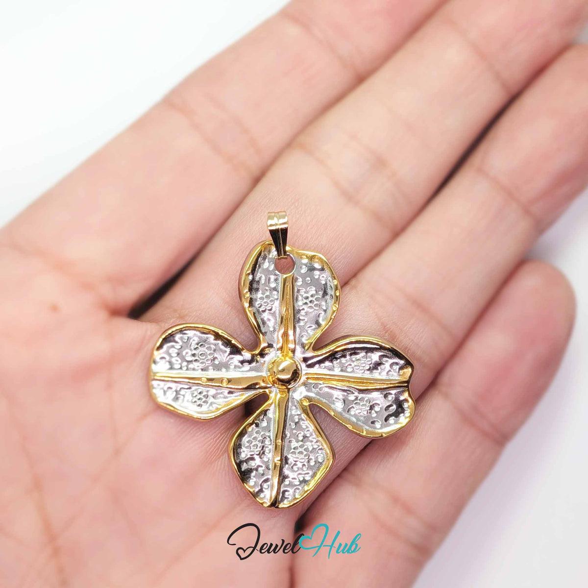 Four Petal Flower pendant in DuoTone stainless steel - held in the hand to show size - JewelHub