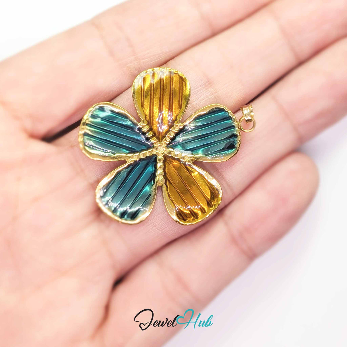 Teal and Amber Enamel Flower pendant in gold-tone stainless steel - held in the hand to show size - JewelHub
