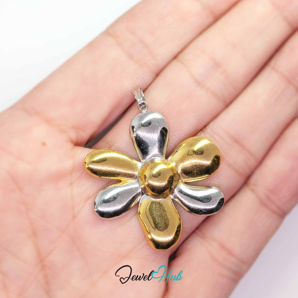 Six Petal Flower pendant in DuoTone stainless steel - held in the hand to show size - JewelHub