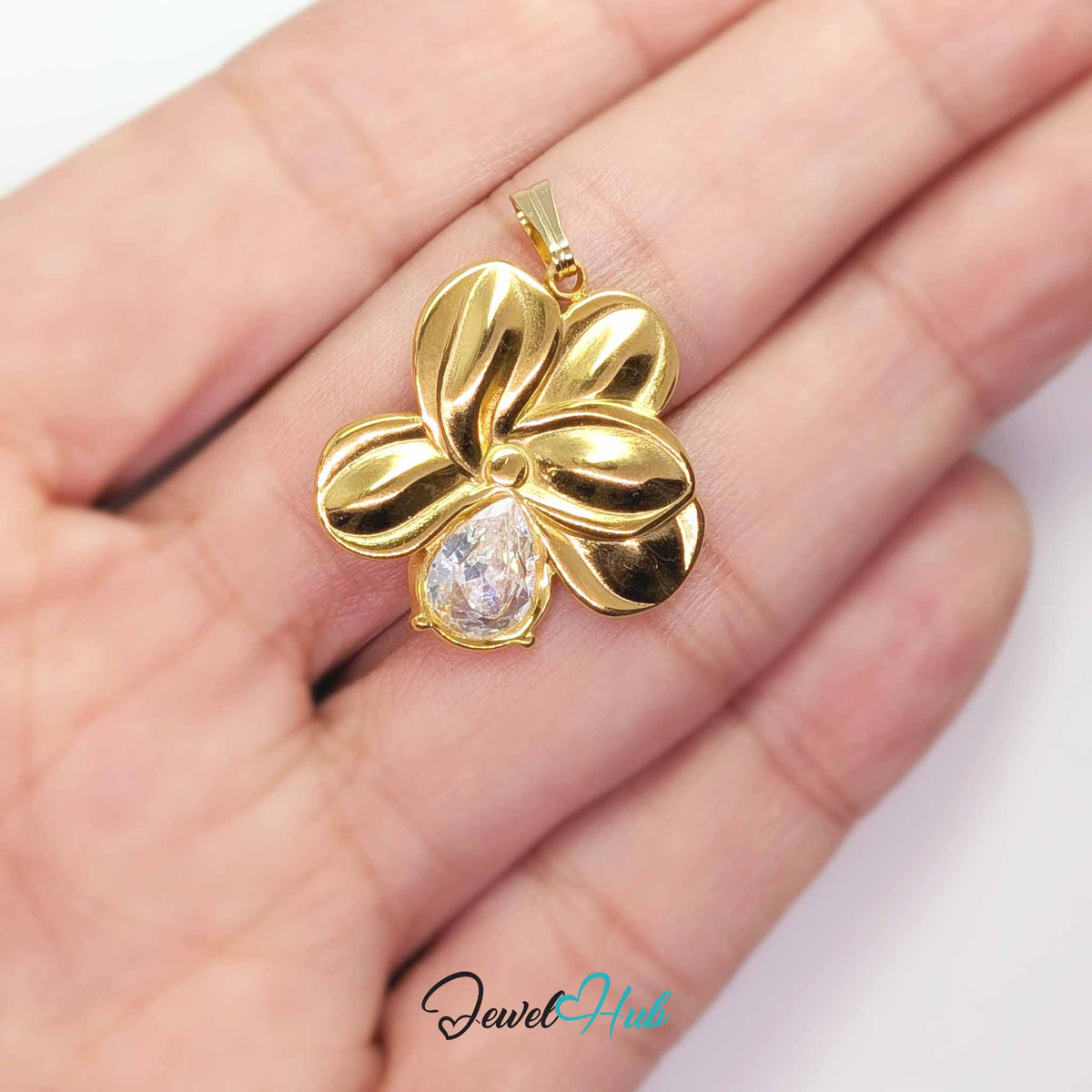 Gold Crystal Flower pendant in gold-tone stainless steel - held in the hand to show size - JewelHub