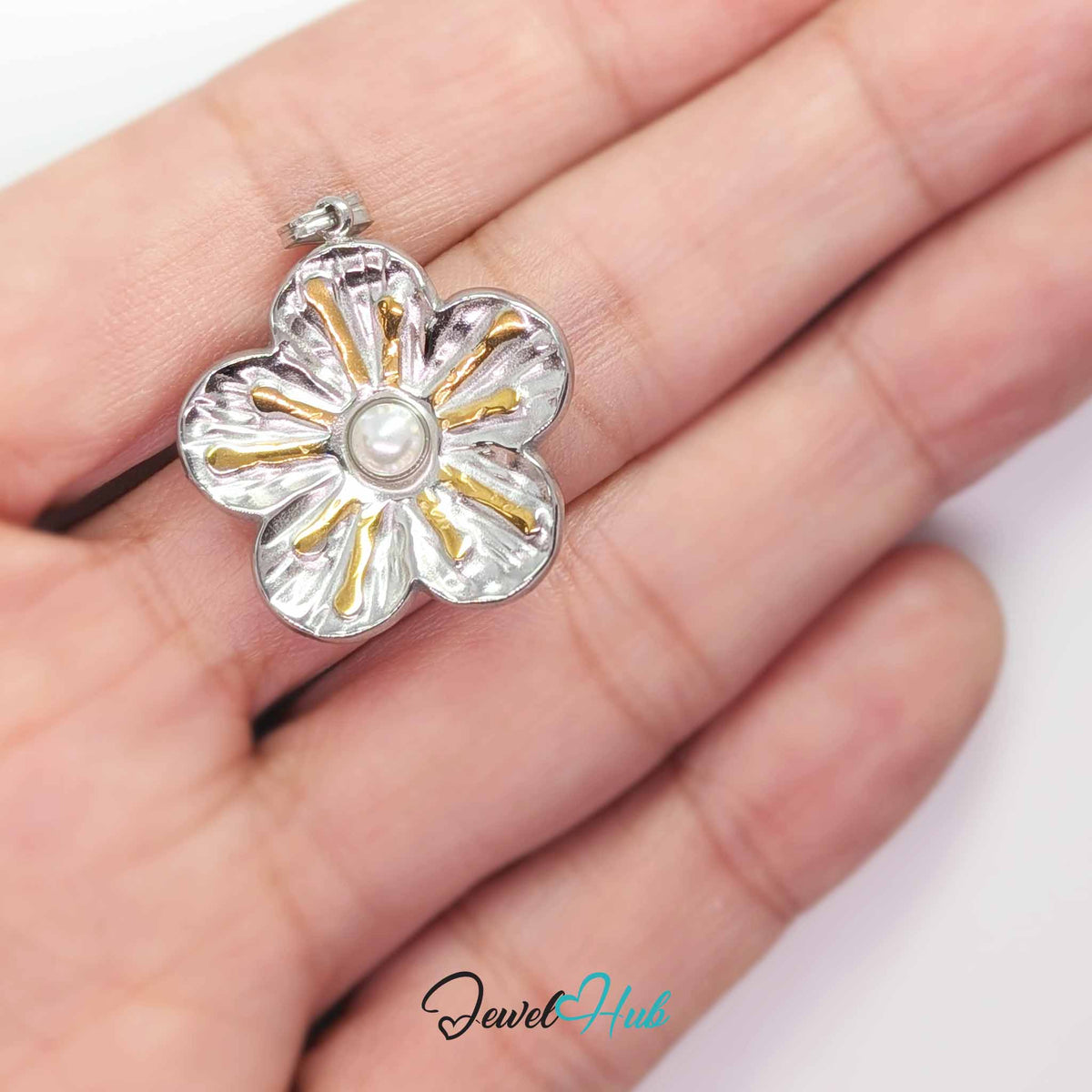 Sunray Pearl Flower pendant in DuoTone stainless steel - held in the hand to show size - JewelHub