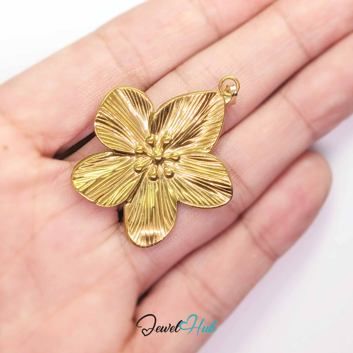 Gold Five Petal Flower pendant in gold-tone stainless steel - held in the hand to show size - JewelHub