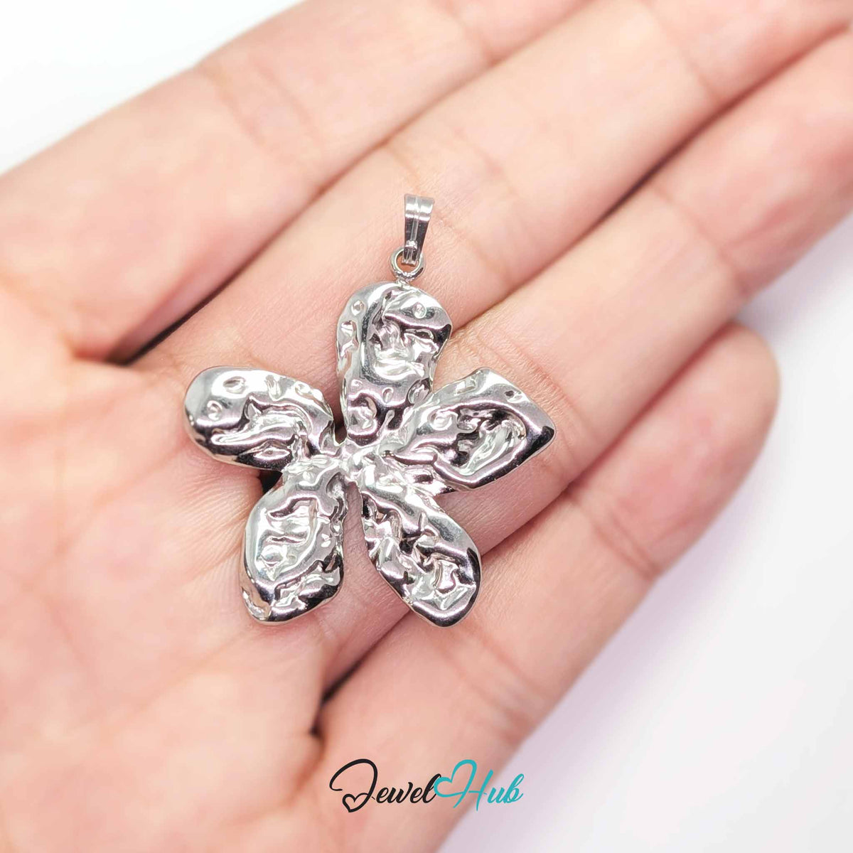 Silver Organic Petal Flower pendant in silver-tone stainless steel - held in the hand to show size - JewelHub