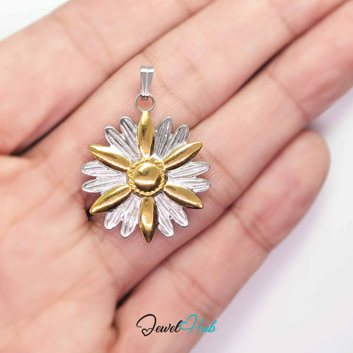 Daisy Flower pendant in DuoTone stainless steel - held in the hand to show size - JewelHub