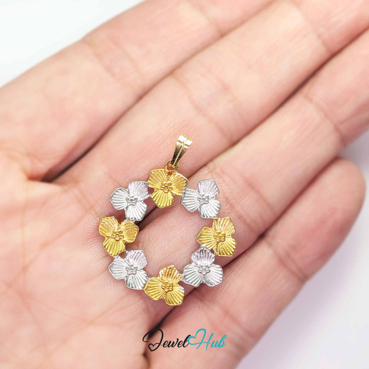 Flower Wreath pendant in DuoTone stainless steel - held in the hand to show size - JewelHub